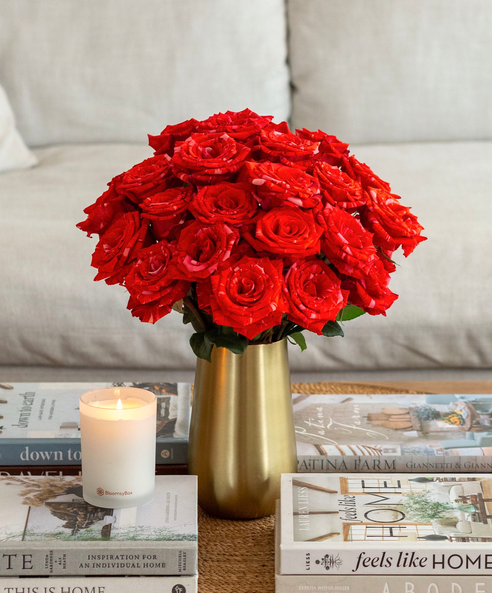 Vibrant red roses arranged in a sleek gold vase, enhancing any living space decor.
